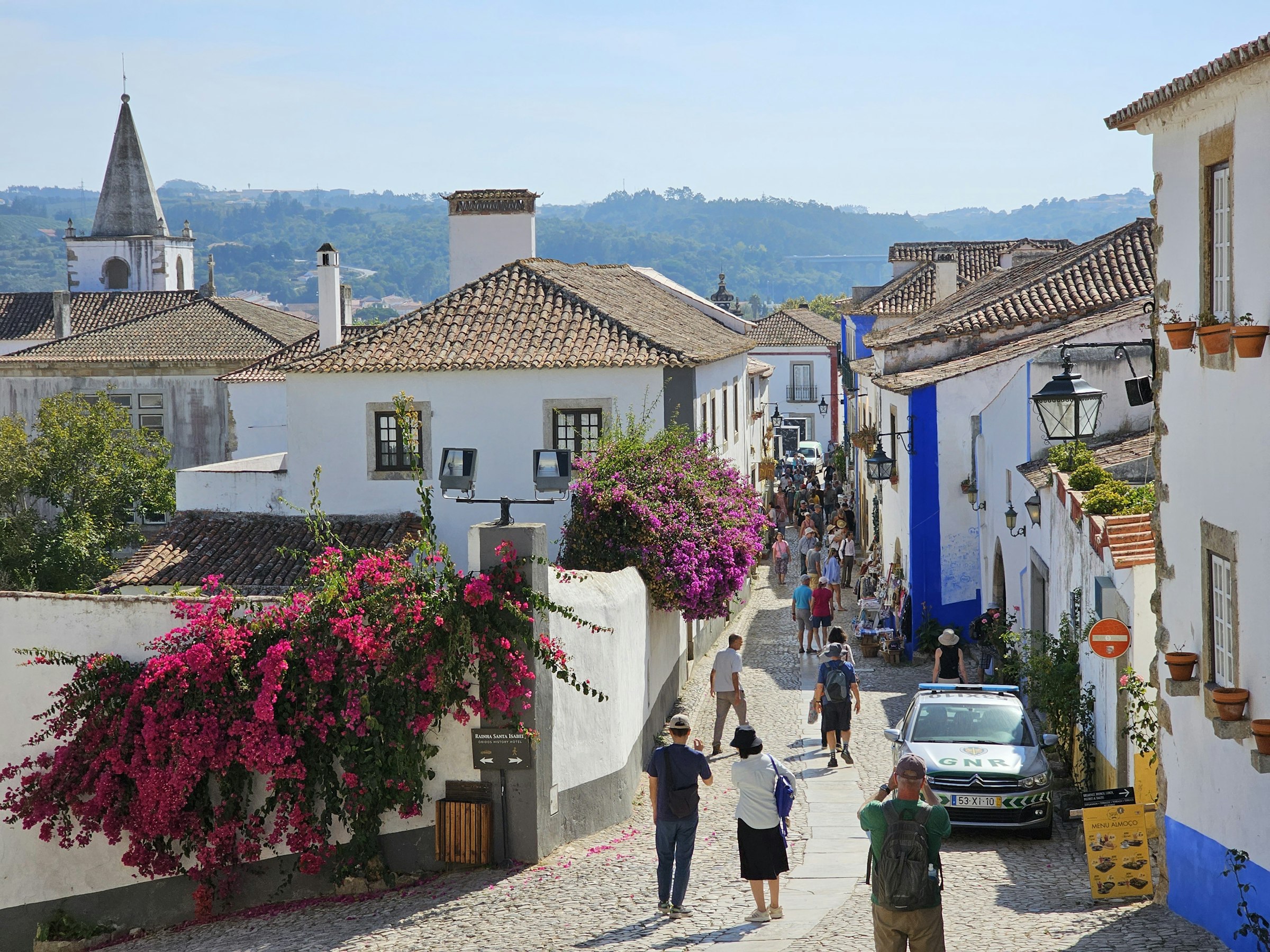 Rua com buganvílias no centro histórico de Óbidos